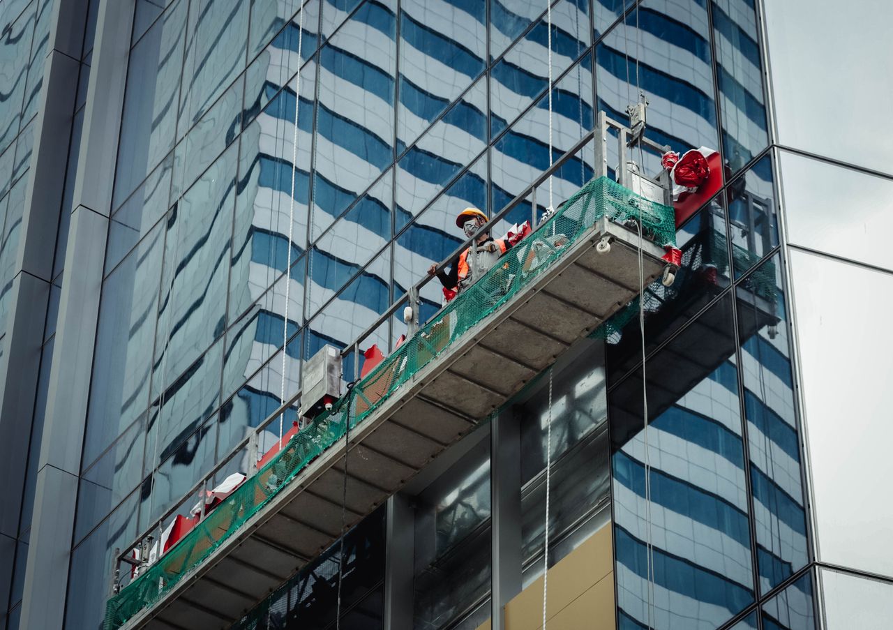 hero-img Urban worker cleaning windows on a high-rise in Ho Chi Minh City, Vietnam.